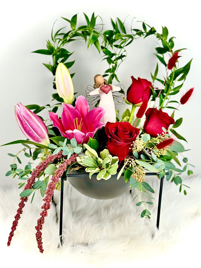 Lilies and red roses on a black stand