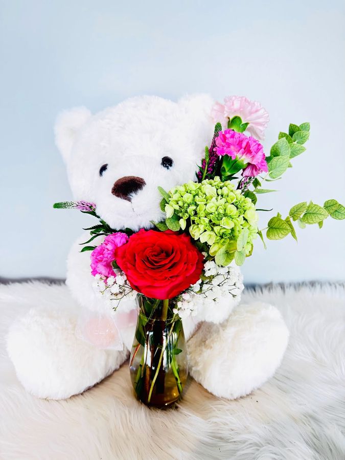 Teddy bear with a red rose vase